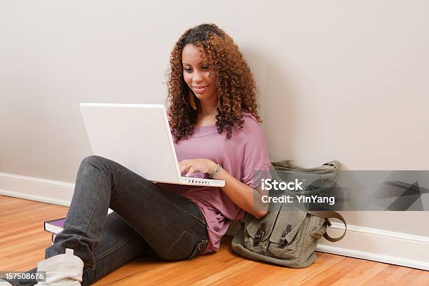 Young Black Female Teen Student Using Laptop On Floor Hz Stock Photo - Download Image Now