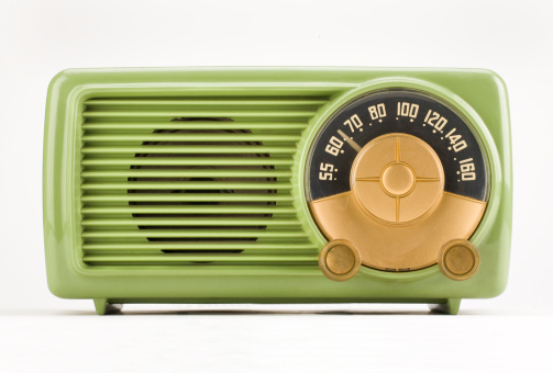 Old style vintage radio over retro mint background with copyspace design.