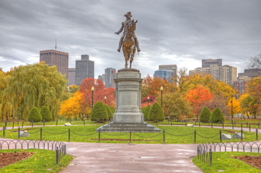 Boston Public Garden during the autumn season with the Equestrian statue of George Washington designed by Thomas Ball.  The Public Garden, also known as Boston Public Garden, is a large park located in the heart of Boston, Massachusetts, adjacent to Boston Common and is the first public garden in the United States.