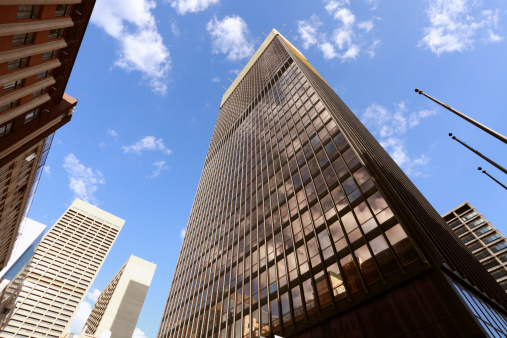 New York, NY, USA - June 4, 2022: One World Trade Center, designed by Skidmore, Owings & Merrill (David M. Childs), with clouds reflected on the facade.