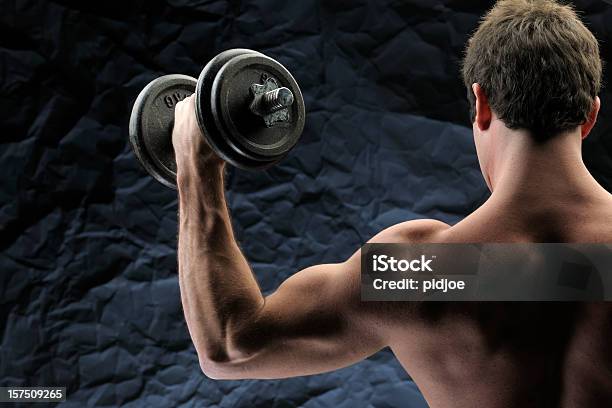 Man Lifting Dumbbells Stock Photo - Download Image Now - Rear View, Black Background, Exercising