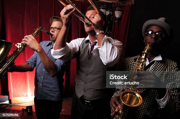 Three Jazz Musicians Playing Music With Red Curtain In Back Stock Photo - Download Image Now