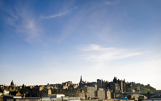 A cityscape of the historic Old Town of Edinburgh, with Edinburgh Castle visible to the right, beyond North Bridge.