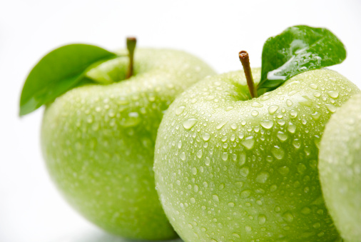 Wet green apples on white background