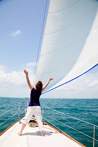 istock ecstatic woman keeping her balance on sailboat 157510256