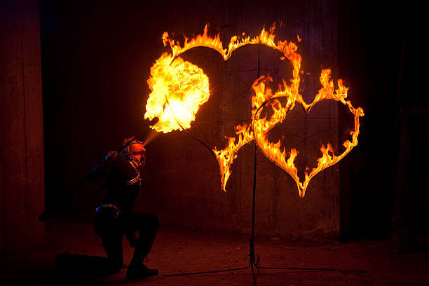 istock Fire performer lighting two flaming hearts 157510397