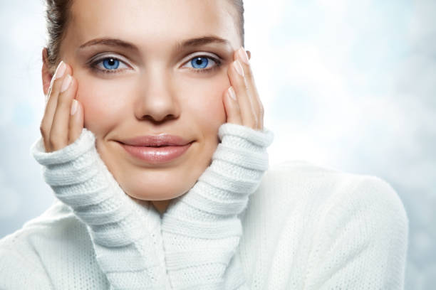 A beautiful young woman in a white sweater stock photo