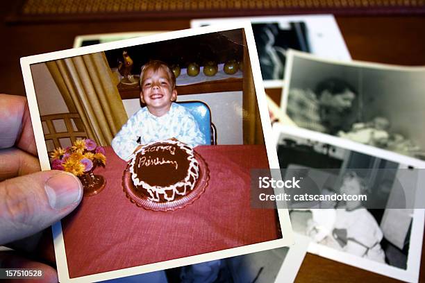 Hand Holds Vintage Photograph Of Child And Birthday Cake Stock Photo - Download Image Now