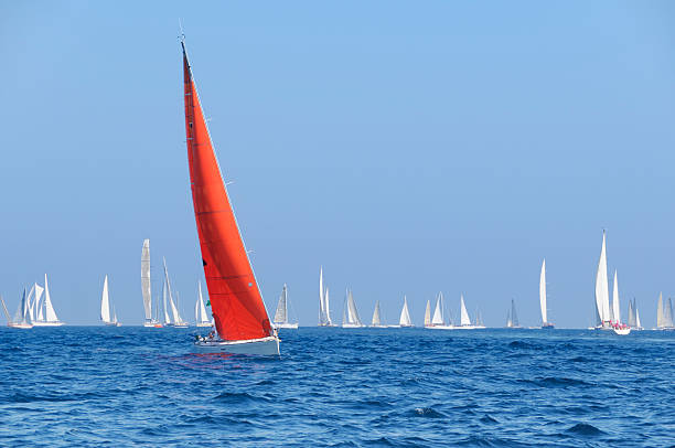 Boat with a red sail during the sailin competition Sailboats during a regatta.  French Riviera regatta stock pictures, royalty-free photos & images