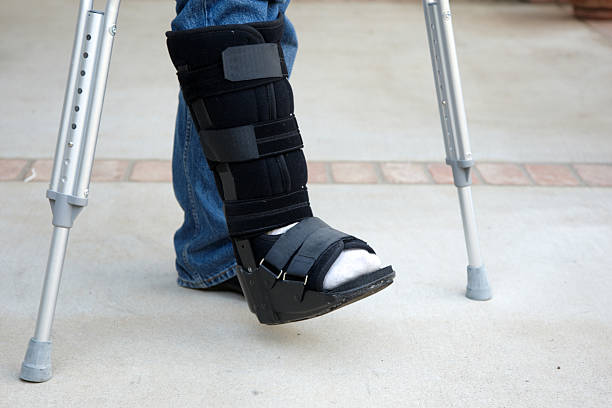 Mature man on crutches Mature man on crutches orthopedic cast stock pictures, royalty-free photos & images