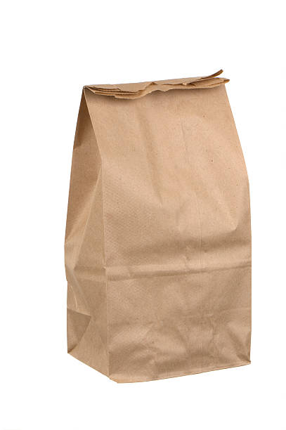 istock Closed brown paper lunch bag on white background 157510832