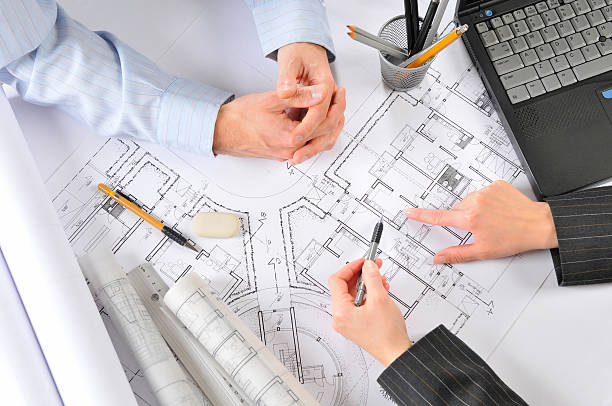 istock Architect is consulting with the client building plans, directly above 157511044