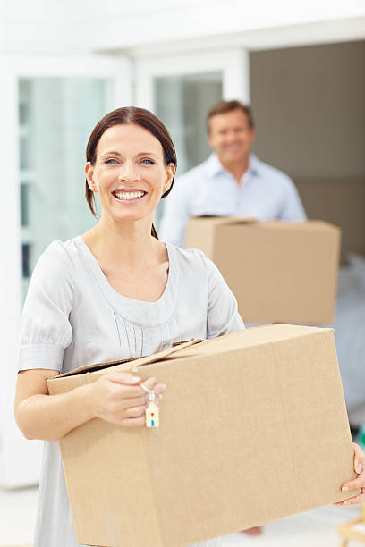 istock Woman holding cardboard box while shifting home 157511143