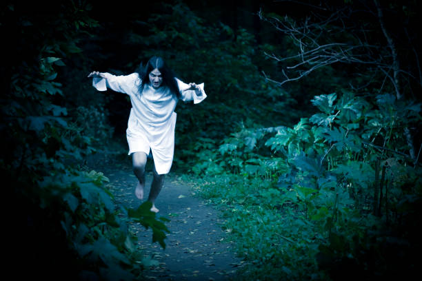 istock Man Wearing Hospital Gown and Running through the forest 157511183