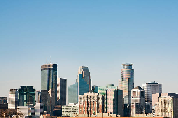 Minneapolis, Minnesota Urban Skyline, Downtown District Daytime Cityscape of Skyscrapers The urban skyline of the downtown districts, the city skyscrapers of Minneapolis, Minnesota, USA under a clear blue sky with copy space. minneapolis stock pictures, royalty-free photos & images