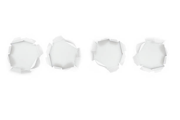 Four hole in a white paper stock photo