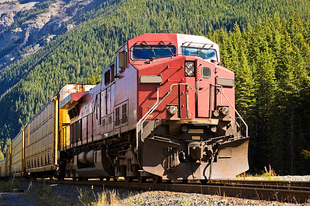 Close-up of train head of a freight train A diesel locomotive at the front of a freight train in the Canadian Rocky Mountains. freight train stock pictures, royalty-free photos & images