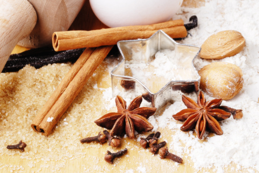 ingredients and tools for baking for xmas-star anise,cloves,cinamon, vanilla,almonds, flour and cookie cutter