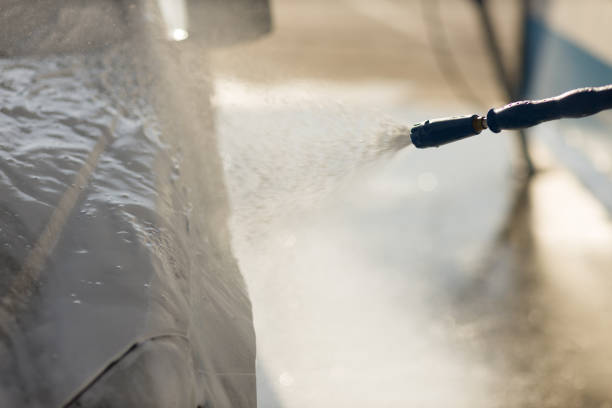 istock Worker washing car at self-service car wash 1575124362