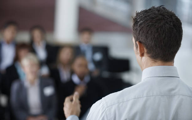 istock Rear view of a businessman giving speech 157512482