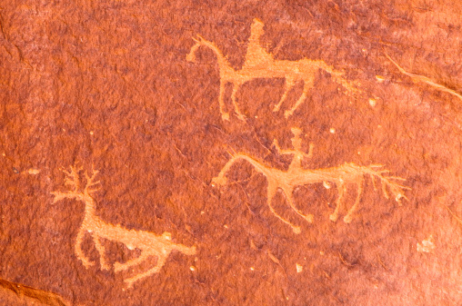 Pictographs of two riders on horseback hunting an elk, moose or deer , Canyon de Chelly, Arizona, USA.