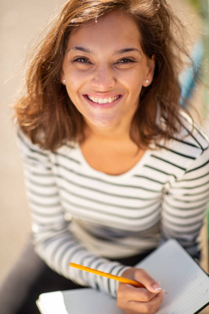 istock above smiling young woman writing in book 1575128870