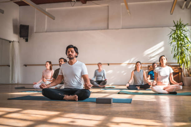 istock Handsome Indian Male Meditation Master With Multiracial Group 1575139909