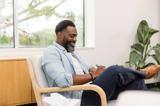 istock Cheerful male therapist takes time between patients to update forms 1575141983