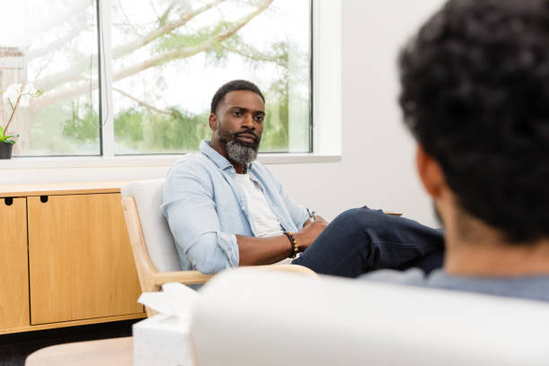 istock Male therapist very concerned about unrecognizable male patient 1575141984