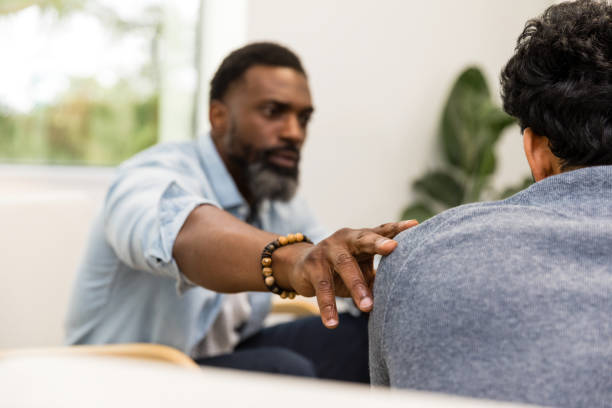 istock Focus on male counselor's comforting hand touching unrecognizable patient's shoulder 1575141995