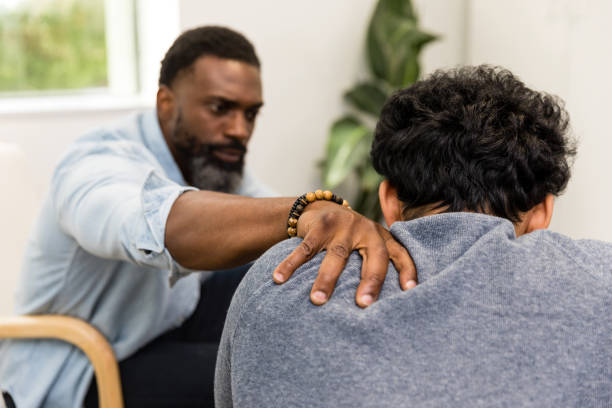 istock Focus on concerned male therapist's hand gripping unrecognizable client's shoulder 1575142028