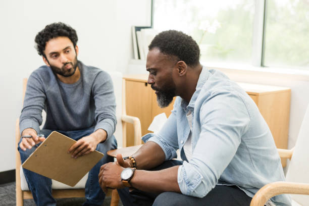 istock Thoughtful young therapist watches distressed male patient 1575143033