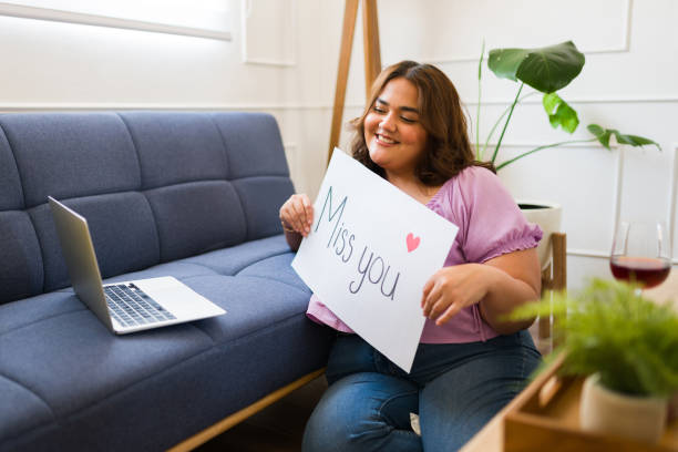 Cheerful woman missing her long-distance boyfriend