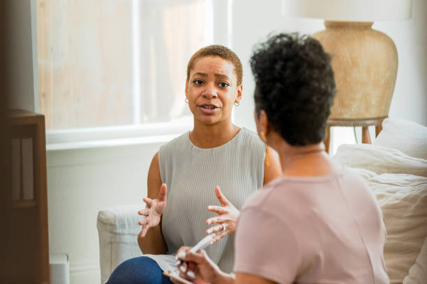 istock Young adult female talks with her therapist about her difficult week 1575171917