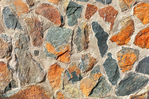 Background of stone wall texture. Close up of colorful stone wall