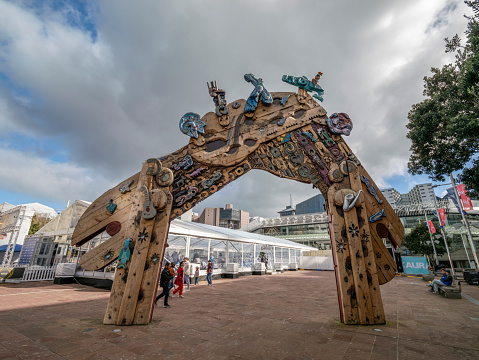 Bilbao, Spain - January, 26, 2017: people at the Guggenheim Museum Bilbao, the museum of modern and contemporary art designed by architect Frank Gehry, opened in 1997, among the most admired works of contemporary architecture, and view of the flower sculpture Puppy, created in 1992 by the artist Jeff Koons