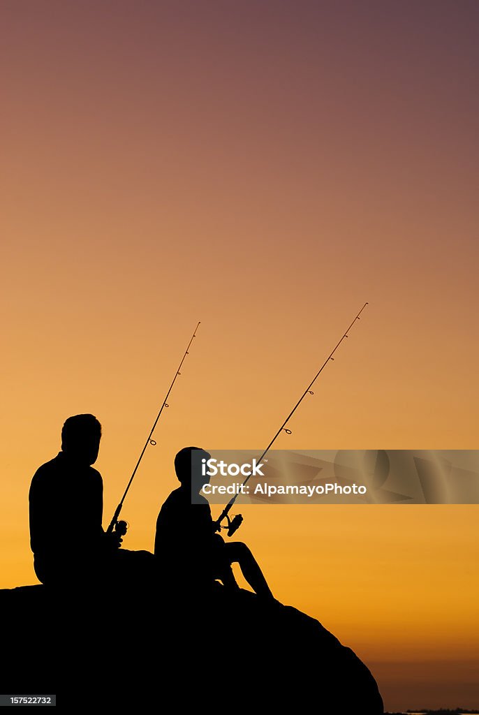 Little Boy And His Grandfather Fishing At Sunset - V  Fishing Stock Photo