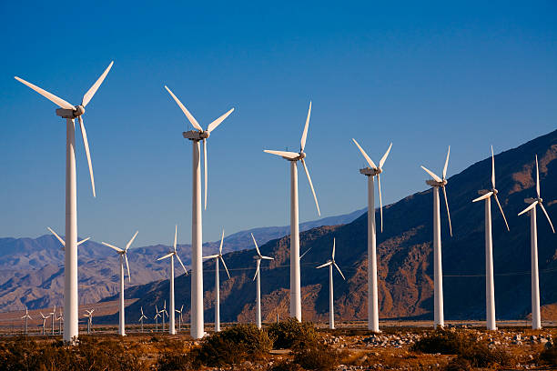 Wind turbines near Palm Springs, CA Wind Farm with numerous wind turbines line the mountain pass near Palms Spring, CA wind turbine photos stock pictures, royalty-free photos & images