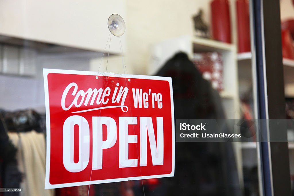 Open sign on shop window Open sign inviting customers to come in Business Stock Photo