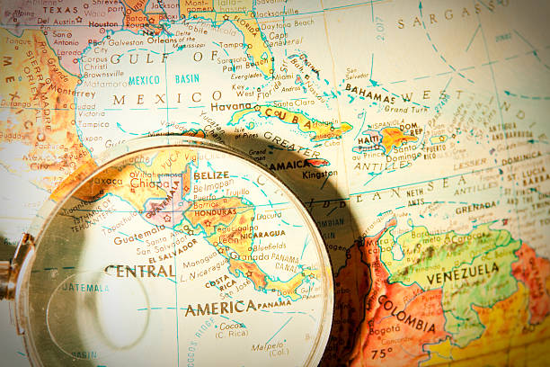Travel the Globe Series - Central America Studying Geography - Photograph of Central America on retro globe underneath a magnifying glass.  central america stock pictures, royalty-free photos & images