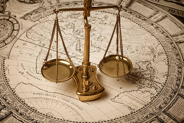 Scale of justice on ancient map Scale of justice and ancient world map aluxum stock pictures, royalty-free photos & images