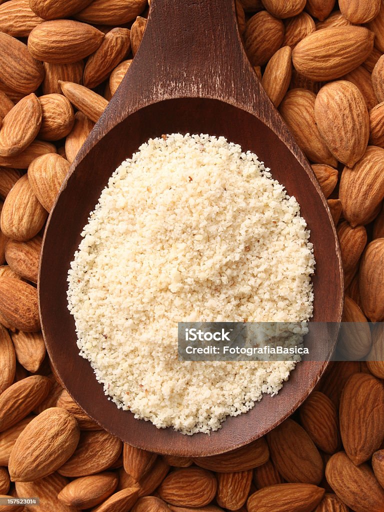 Almond flour Top view of wooden spoon full of almond flour Almond Stock Photo