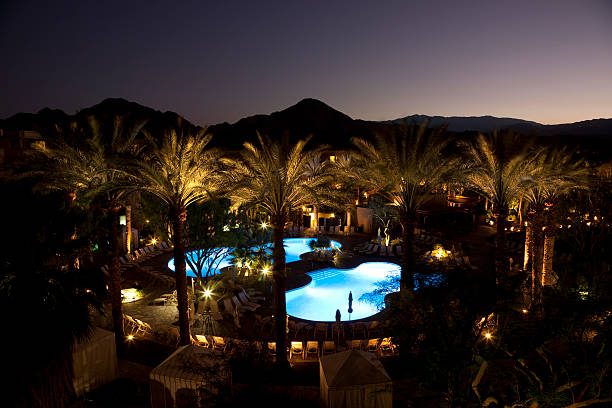 istock Luxury Resort Pools At Night With Palm Trees, Sunset, Mountains 157523087