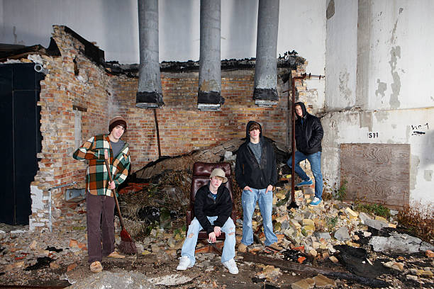 Group of Young Adults Group of young adults (Alternate Rock band) in gritty urban setting. Can be late teens or early twenties. boy band stock pictures, royalty-free photos & images