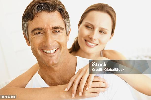 Pretty Woman Embracing Her Husband Stock Photo - Download Image Now - 30-34 Years, 30-39 Years, 40-44 Years