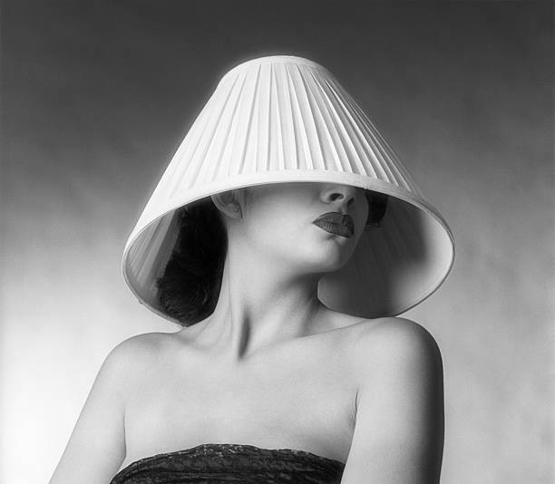 A fashion shot of a woman with a lampshade on her head Bad hair day? Disappointed with her new do from her last salon visit? Just a wild and crazy party girl? lamp shade stock pictures, royalty-free photos & images