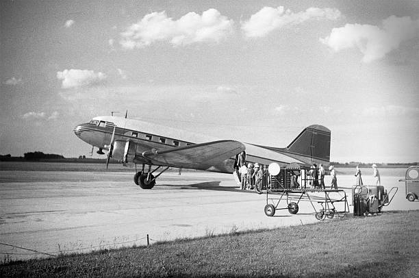 DC-3 airliner loading passengers 1951, retro Commercial passenger airplane in 1951. DC-3. Scanned film with significant grain. passenger photos stock pictures, royalty-free photos & images