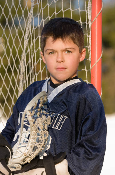young boy portrait in lacrosse uniform