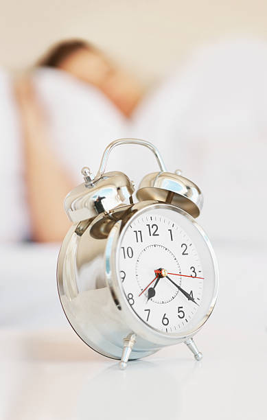 istock Alarm clock with a person at the back 157524030