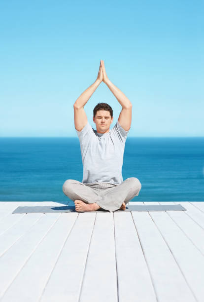 istock Adult man meditating on a dock 157524031